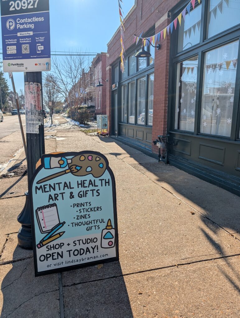 Sandwich board in front of untold media inc storefront